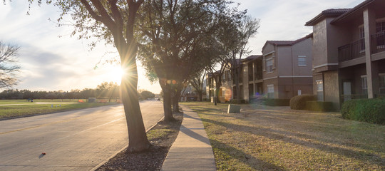 Wall Mural - Sunset.Typical apartment near public park in Irving, Texas, USA at sunset. Concrete trail for walking, jogging, biking.