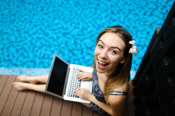 Wall Mural - portrait of happy woman and laptop. girl looking at camera happy, concept of new technologies, compu