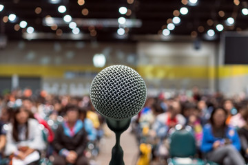 microphone over the abstract blurred photo of conference hall or seminar room in exhibition center b