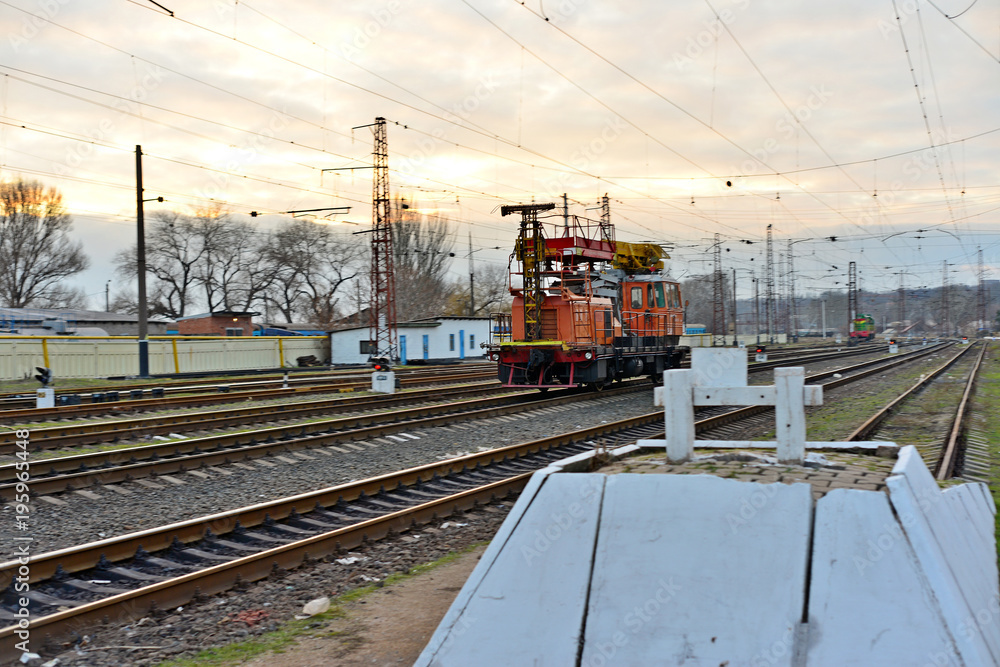 Railway station against beautiful sky at sunset. Industrial landscape with railroad, colorful cloudy blue sky. Railway sleepers. Railway junction. Heavy industry. Cargo shipping. Travel background - obrazy, fototapety, plakaty 