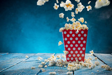 Box Of Popcorn On Blue Background.