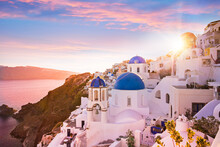 Sunset View Of The Blue Dome Churches Of Santorini, Greece.