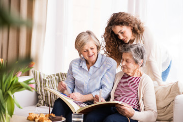 Wall Mural - A teenage girl, mother and grandmother at home.