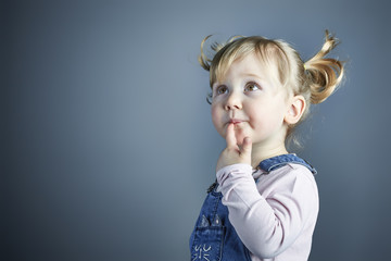 3 year old blonde caucasian girl with pigtails with happy and funny expression. concept of carefree and childhood.