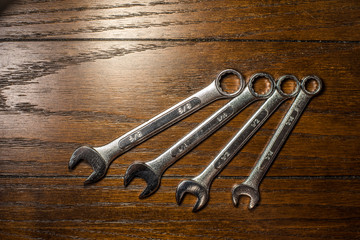 Wrenches on Wooden Table Background 