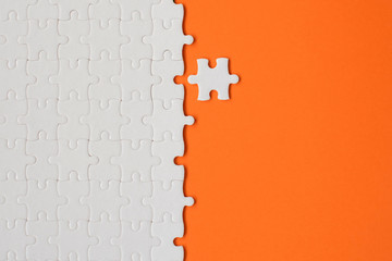 Wall Mural - White details of puzzle on orange background
