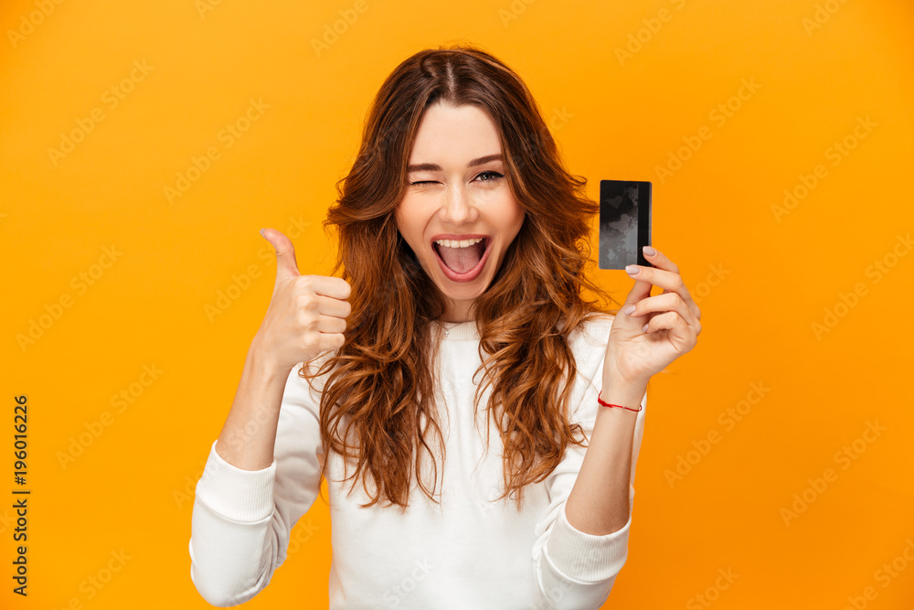 Cheerful brunette woman in sweater showing thumb up - obrazy, fototapety, plakaty 