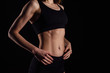 © artyme - Sexy body of young attractive athletic girl. Muscular woman on black background.