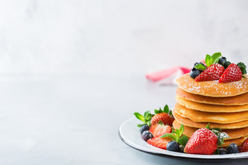 Stack of homemade pancakes for breakfast with berries