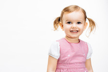 Smiling Toddler Girl With Ponytails Looking Upwards