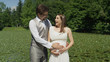 © helivideo - Excited young embraced couple feeling their unborn baby kick for the first time.