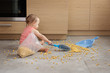 © Lisa Tichané - Baby cleaning up spilled bag of cereal