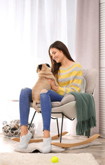 Canvas Print - Woman with cute dog at home. Friendship between pet and owner