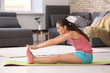 © Africa Studio - Beautiful young woman doing fitness exercise at home