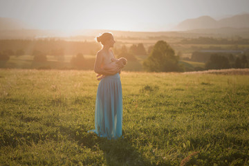 mother and baby breastfeeding outdoor 