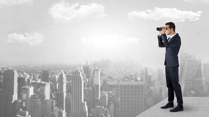 Wall Mural - man looking forward from the top of a skyscraper