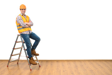 Wall Mural - The builder standing on the ladder on the white wall background