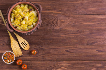 Wall Mural - Top view of clay pots with hot roast potatoes