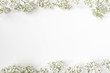 Styled stock photo. Feminine wedding desktop with baby's breath Gypsophila flowers on white background. Empty space. Floral frame, web banner. Top view. Picture for blog or social media.