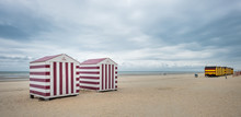 Row Of Colorful Beach Huts On A Cloudy Day
