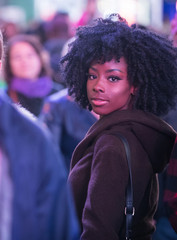 Poster - Pretty African American Girl looking back over her shoulder in crowded city