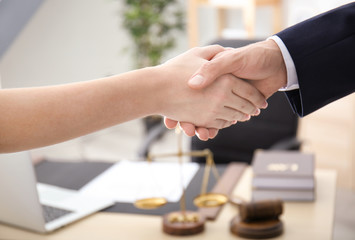 Wall Mural - Lawyer shaking hands with client in office, closeup