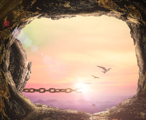 Fototapete - International migrants day concept: Silhouette birds flying and broken chains at empty tomb stone autumn sunset background