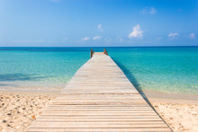 Wooden Bridge On The Tropical Beach And Blue Sky