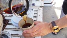 Hand Drip Coffee, Barista Pouring Hot Water Over Roasted Grinded Coffee Powder Making Drip Brew Coffee