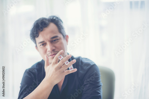 Close up of businessman throwing dice. Gambling concept плакат