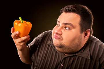 Diet fat man eating healthy food . Health breakfast with vegetables cauliflower and sweet pepper with radish for overweight person. Caricature of a fat man. Dietary breakfast.