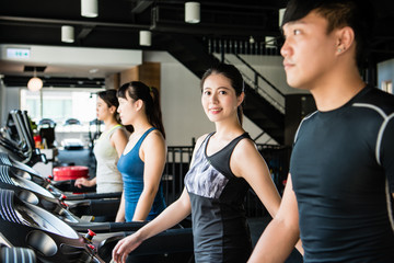 Wall Mural - Woman exercising on treadmill and smiling