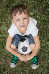 Portrait of a young  boy with soccer ball.