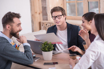 Sticker - Strict deadline. Smart positive confident man holding the calendar and looking at it while telling his team about deadlines