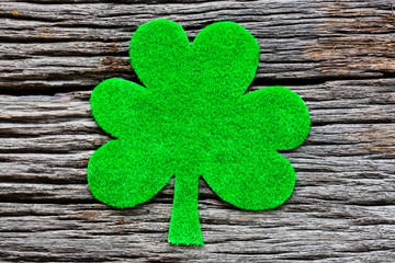Wall Mural - Happy St Patricks Day message with green clover leaf on wooden background