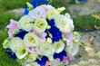 Various fresh flowers arrangement in bouquet, close up detail front view on yellow stone surface grass. Bright romantic pure fresh flowerheads collected in bouquet for wedding celebration.