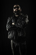 © Atomazul - Tough guy in black leather jacket and sunglasses with arms crossed.