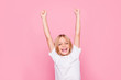 © deagreez - Holiday weekend event fortune luck delight rejoice people lifestyle leisure concept. Portrait of charming cheerful emotional excited joyful girl raising hands up isolated on gray background