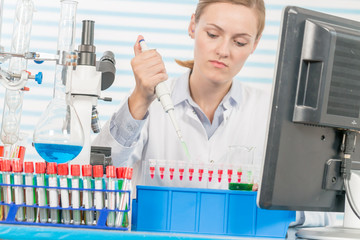 Poster - Experiments in the chemical laboratory, Female researcher using her test tube in a laboratory