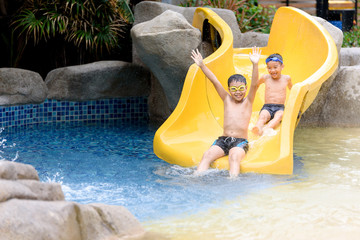 Young boy play water slide