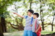 © TinPong - Preteen Asian boy travel in a forest in summer and learn about nature and tree.