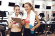 © freeograph - Mother and daughter using tablet at the gym. They look happy, fashionable and fit.