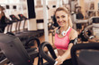 © freeograph - Woman with headphones running on treadmill at the gym. They look happy, fashionable and fit.