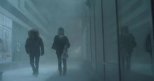 Two People Are Trying To Come Through The Blizzard In A Windy Winter Night