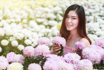 Wall Mural - beautiful woman in chrysanthemum glower garden