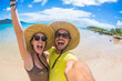 © Davide Angelini - Crazy couple in love having fun taking a selfie at a tropical beach at holiday