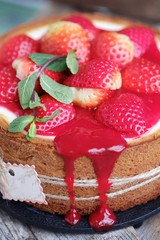 Delicious beautiful cheesecake with strawberries and mint 