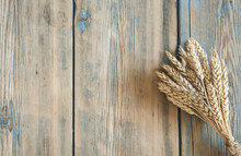 Ears Of Wheat On Wooden Background