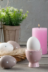  Eggs and rose aroma candle on old wooden background