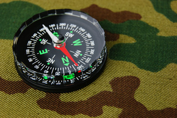 Wall Mural - Compass on a camouflage background